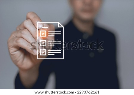 Man using a laptop and touching on virtual screen contact questionnaire with checkboxes,E-signing on an e-document, electronic signature, paperless office concept,Take an assessment,Online survey