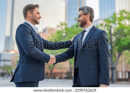 American businessman shaking hands with partner. Two businessmen shaking hands outdoors. Shaking hands. Management strategy. Handshake between two businessmen. Communication of business concept. Royalty-Free Stock Photo #2290762629