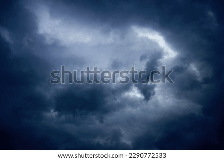 Fine art: landscape photo of dark clouds, threatening a thunderstorm, blue tint  