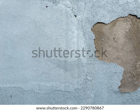 Abstract old white concrete wall with peeling paint background texture, close up, detail.  Empty weathered cement surface with peeling stucco