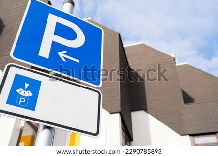 Blue vehicle parking sign with time parking meter and copy space for text Royalty-Free Stock Photo #2290785893