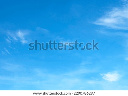 blue sky background with tiny clouds Royalty-Free Stock Photo #2290786297
