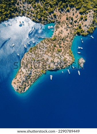 Aerial drone photo of Binlik Bay, located in the midst of Göcek and Dalaman, Fethiye. Daily tour boats and private yachts anchor to have serenity and enjoy the secluded bay. Royalty-Free Stock Photo #2290789449