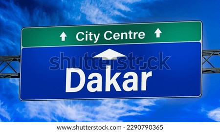 Road sign indicating direction to the city of Dakar.