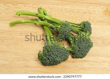 Fresh tender stem broccoli on a wooden board Royalty-Free Stock Photo #2290797777