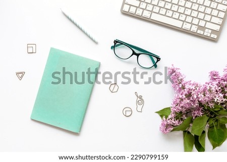 Top view of beautiful desktop with computer and spring flowers bouquet.