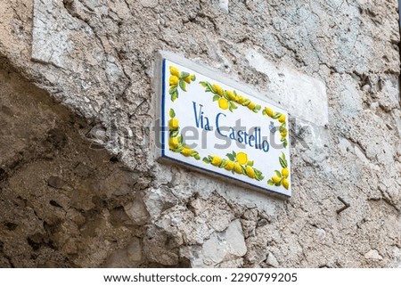 Limone sul Garda, Italy - April 8, 2023: Street sign "Via Castello" in Limone sul Garda decorated with lemons on the old street Royalty-Free Stock Photo #2290799205
