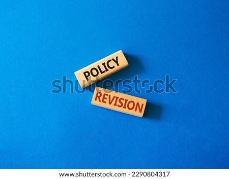 Policy revision symbol. Concept word Policy revision on wooden blocks. Beautiful blue background. Business and Policy revision concept. Copy space