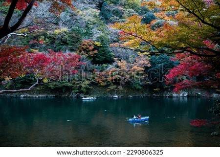 Hozugawa River Boat Ride in Autumn, Blue Rowboat, Red Yellow Orange Autumn Leaves Scenery