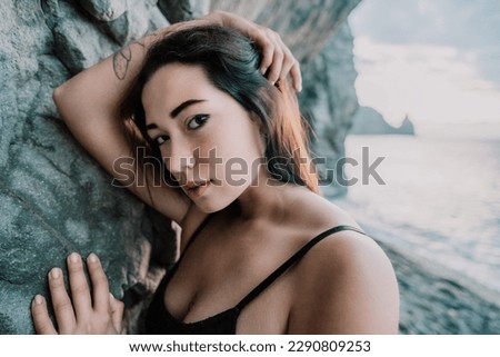 Portrait of cheerful female climber resting on a volcanic basalt