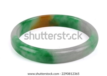 A green jade bangle. Isolated on white. Royalty-Free Stock Photo #2290812365