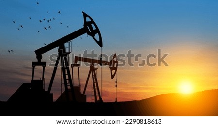 The change in oil prices caused by the war. Oil price cap concept. Oil drilling derricks at desert oilfield. Crude oil production from the ground. Petroleum production. Royalty-Free Stock Photo #2290818613