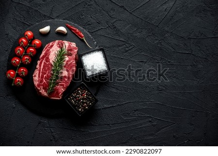 raw marbled beef steak on stone background with copy space for your