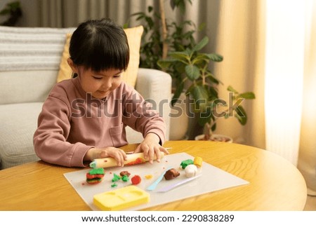 A child staying up late playing with clay