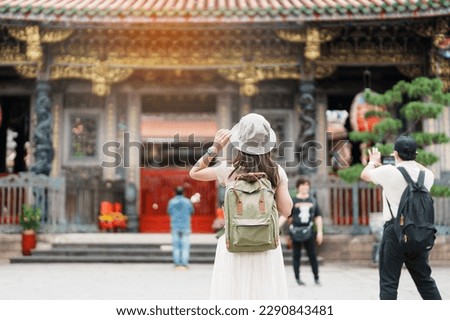 woman traveler visiting in Taiwan, Tourist with hat sightseeing in Longshan Temple, Chinese folk religious temple in Wanhua District, Taipei City. landmark and popular. Travel and Vacation concept Royalty-Free Stock Photo #2290843481