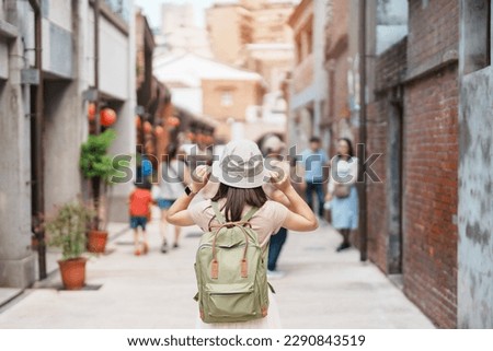 woman traveler visiting in Taiwan, Tourist with backpack and hat sightseeing in Bopiliao Historic Block, landmark and popular attractions in Taipei city. Asia Travel Royalty-Free Stock Photo #2290843519