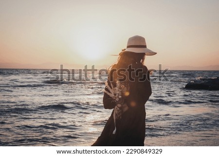 It is a picture of a beautiful sea and a woman