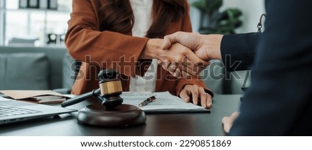 Shaking hands, Bribery of female asia japanese chinese lawyer people earn dollars after winning a lawsuit. extorting money from clients in legal cases Royalty-Free Stock Photo #2290851869