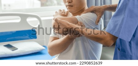 Athlete undergoing physiotherapy with a musculoskeletal specialist after sports and gym injuries. Royalty-Free Stock Photo #2290852639