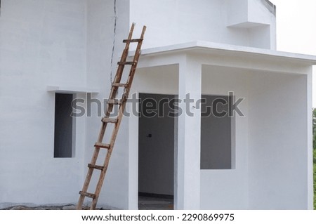 Traditional ladder used to paint new buildings