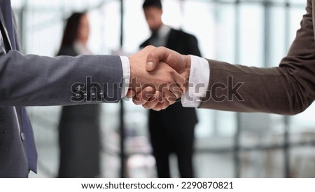 Close-up of business partners handshaking after successful agree Royalty-Free Stock Photo #2290870821