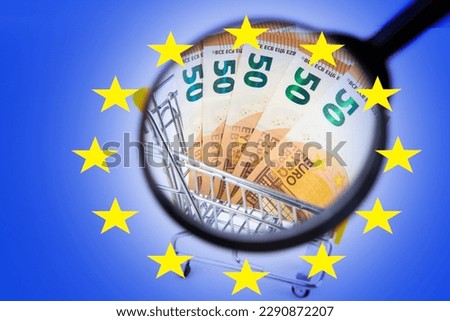 European union money. Flag of europe with banknotes. Eurozone money under magnifying glass. Financial market of European union. Investments in EU. Banknotes in shopping cart. Euro money.  Royalty-Free Stock Photo #2290872207
