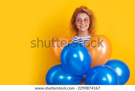 party woman with balloon in sunglasses. smiling woman hold party balloons in studio.