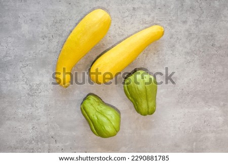 Top view of two different types of squash, chayotes and crookneck squash.