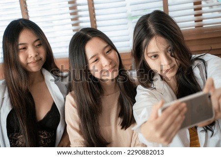 Women friend enjoy in office selfie photo with smartphone sitting on sofa happy team