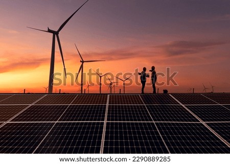 Silhouette engineer working on solar cell plant with windmill field .Solar cell smart grid and windmill are ecology energy renewable sunlight alternative green power environment factory concep.t Royalty-Free Stock Photo #2290889285