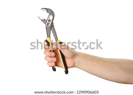 Hand holds adjustable pliers to repair something. Isolated object on white. Do it yourself Royalty-Free Stock Photo #2290906603