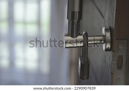 padlock hanging above the door handle