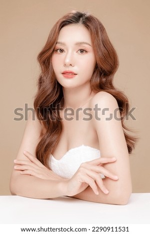Young Asian beauty woman curly long hair with korean makeup style on face and perfect skin on isolated beige background. Facial treatment, Cosmetology, plastic surgery. Royalty-Free Stock Photo #2290911531
