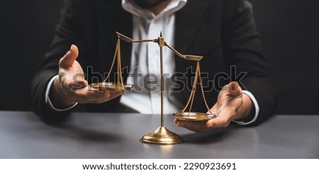 Lawyer or judge in formal black suit hold unbalanced scale with expression of disappointment trying to fix imbalance as anti-injustice concept to fight against corruption of legal system. equility Royalty-Free Stock Photo #2290923691