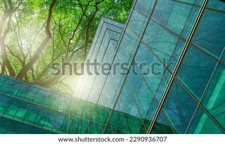 Sustainble green building. Eco-friendly building in modern city. Sustainable glass office building with tree for reducing carbon dioxide. Office with green environment. Corporate building reduce CO2. Royalty-Free Stock Photo #2290936707