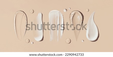 cosmetic smears of creamy texture on a beige background Royalty-Free Stock Photo #2290942733