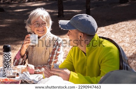 Family Couple Bonding Enjoying Together Outdoors Excursion in Mountain, have break with food and drink