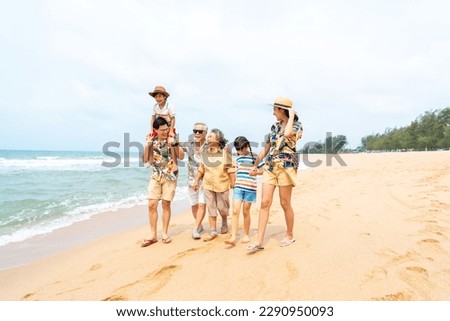 Group of Asian Multi-Generation family in casual clothing enjoy and fun outdoor lifestyle walking and playing together at tropical beach during travel island ocean at sunset on summer holiday vacation Royalty-Free Stock Photo #2290950093