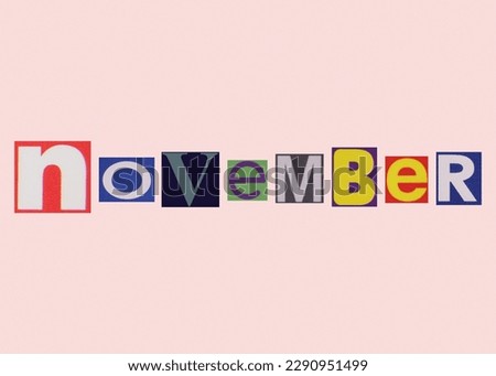 November word from cut out magazine colored letters on a light background