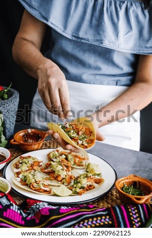 Mexican woman hands preparing tacos al pastor and eating traditional mexican food in Mexico Latin America, hispanic people