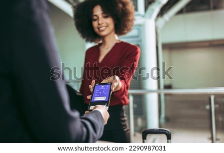 Woman traveler boarding to the plane showing smart phone ticket at the boarding entrance. Female passenger using electronic boarding pass to board a flight at airport. Royalty-Free Stock Photo #2290987031