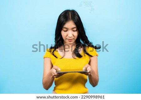 Portrait, beautiful woman with long hair asian, playing fun frantic game where competes against friends until causing accidentally smile laugh out loud, Isolated indoor studio on blue background.