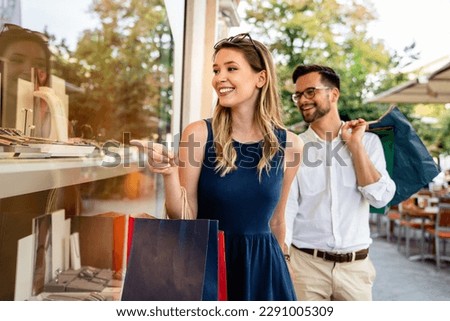 Portrait of a couple with shopping bags in the city. People sale love and happiness concept. Royalty-Free Stock Photo #2291005309