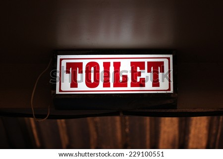 LED signs provide directional to the toilet.