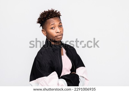 Dark skinned fashionable guy in stylish outfit looking at camera posing for advertisment magazine online shopping online concept.