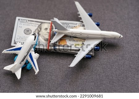 Flatlay picture of toy airplane, fake money