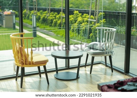 Enhance the home's ambiance with an elegant coffee table and chair set. A perfect blend of style and comfort that will elevate any living space. selective focus. over-exposed in certain areas.
