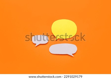 Blank paper speech bubbles on orange background Royalty-Free Stock Photo #2291029179