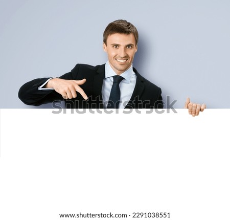 Image of business man professional bank manager confident formal black suit. Businessman stand behind, hang over show point finger empty white banner signboard sign board Isolated grey gray background