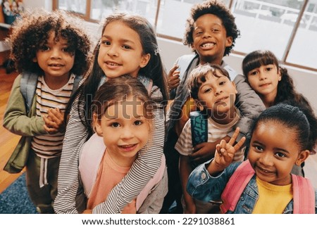 Class selfie in an elementary school. Kids taking a picture together in a co-ed school. Group of elementary school children feeling excited to be back at school.